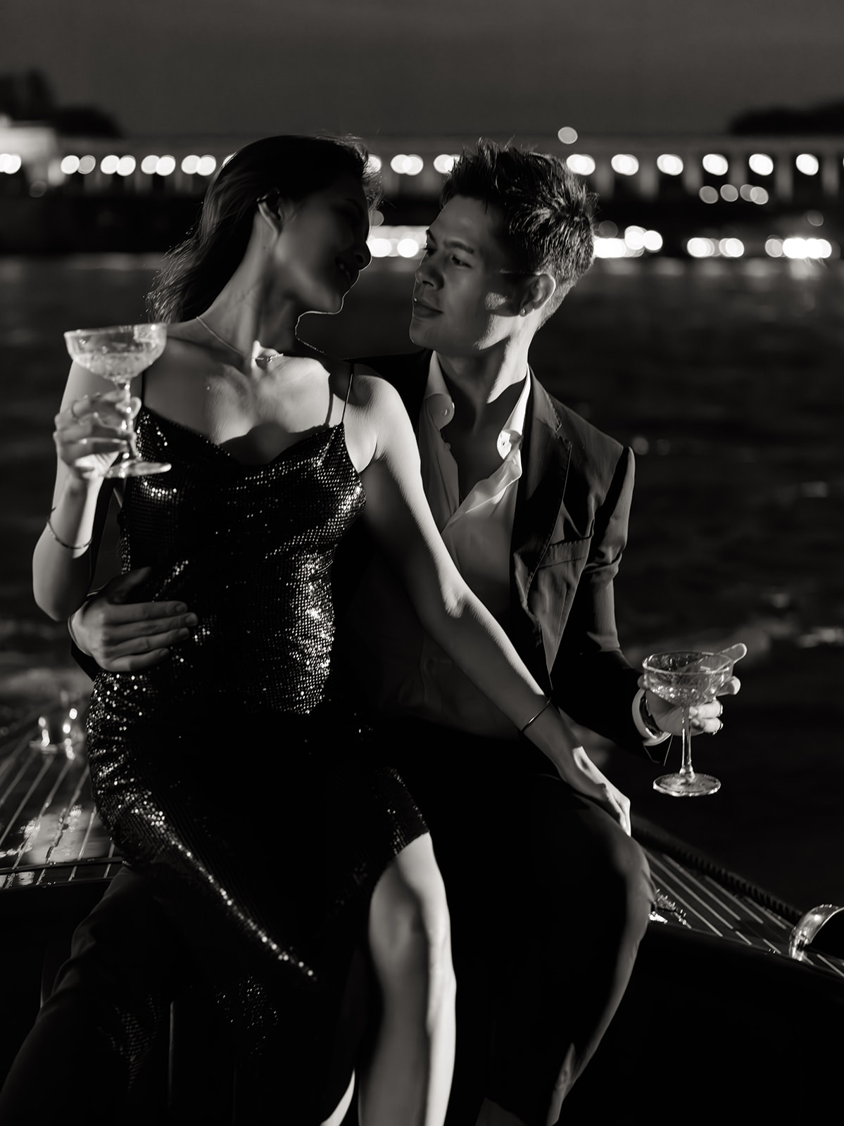 Black and white engagement portrait with champagne aboard a private boat on the Seine